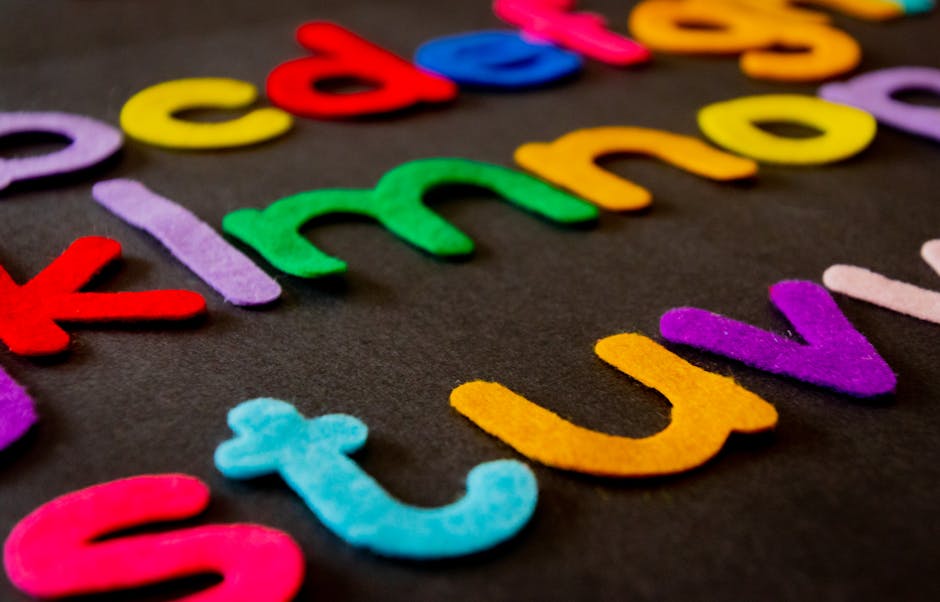Bright and colorful felt alphabet letters arranged on a dark surface, perfect for educational and creative projects